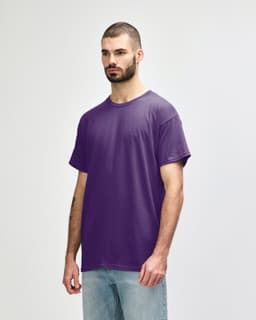 A purple Gildan Heavy Cotton adult T-shirt displayed on a model, featuring a blank design and no visible logos.