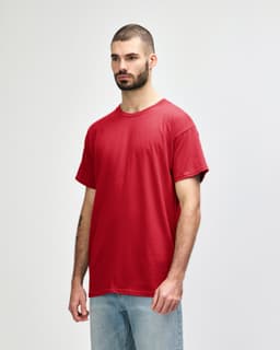 A red Gildan Heavy Cotton Adult T-Shirt displayed on a model, featuring a simple design and a logo.