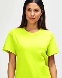 A bright yellow Gildan Heavy Cotton Adult T-Shirt is displayed on a model with short dark hair.