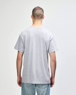 A grey Gildan Heavy Cotton adult t-shirt with short sleeves, viewed from the back. It features a logo on the label.