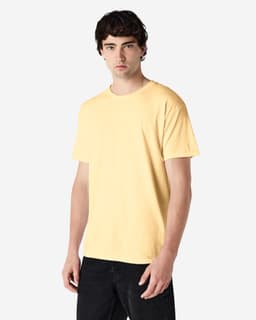 A yellow Gildan Heavy Cotton Adult T-Shirt displayed on a model, featuring a simple design and a logo.