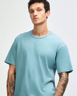 A unisex short sleeve t-shirt in a light blue colour, featuring a casual fit and a logo.