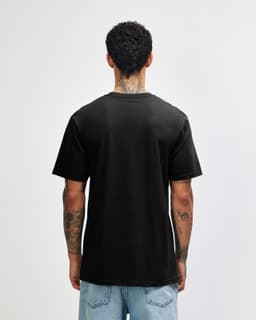 A black unisex short sleeve T-shirt displayed from the back, with a visible logo on the fabric.
