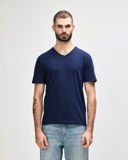 A navy adult v-neck t-shirt displayed on a male model, featuring a subtle logo.