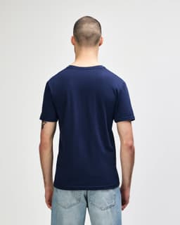 A navy Gildan Softstyle adult V-neck T-shirt, viewed from the back, featuring a simple design with minimal detailing.