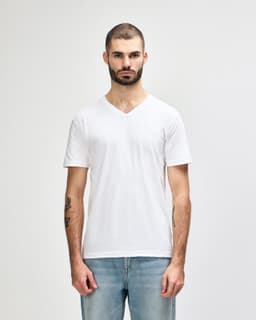 A white Gildan Softstyle adult V-neck T-shirt displayed on a male model, featuring a simple design and a branding logo.