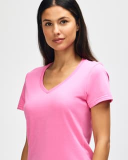 A pink Gildan Softstyle ladies' V-neck T-shirt displayed on a model, featuring a fitted design.