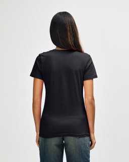 A black Gildan Softstyle ladies' V-neck T-shirt displayed from the back on a model.
