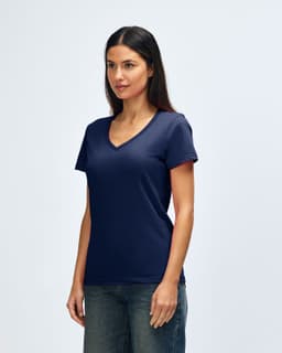 A navy Gildan Softstyle ladies' V-neck T-shirt displayed on a model, with a simple and minimalist design.