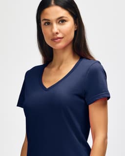 A navy Gildan Softstyle ladies' V-neck T-shirt displayed on a model, featuring a fitted design and short sleeves.