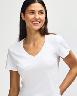 A white Gildan Softstyle ladies' v-neck t-shirt displayed on a model, featuring a fitted design and short sleeves.