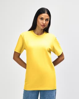 A yellow midweight T-shirt worn by a model, featuring a logo on the garment.