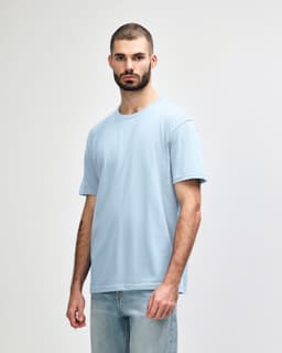 A midweight adult T-shirt in a light blue colour, featuring a round neck and short sleeves, with a logo.