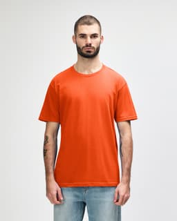An orange midweight T-shirt for adults, displayed on a model with a neutral background. Features a logo.