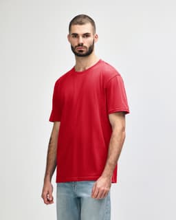 A red midweight t-shirt on a model, featuring a simple design and a logo on the shirt.