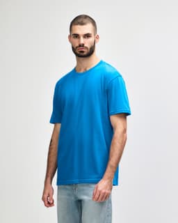 A blue Gildan Softstyle adult midweight t-shirt featured on a model against a plain background.