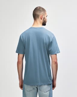 A softstyle adult midweight t-shirt in blue with yellow side panels, featuring a logo on the back.