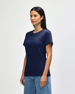 A navy Gildan Softstyle ladies midweight T-shirt displayed on a model, featuring a simple design and a logo.