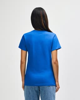 A blue Gildan Softstyle ladies midweight T-shirt displayed from the back, featuring a simple design.