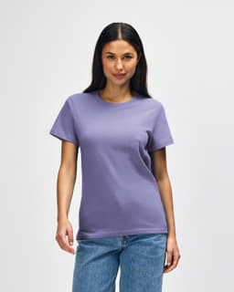 A purple Gildan Softstyle ladies midweight T-shirt displayed on a model, featuring a simple design without text.