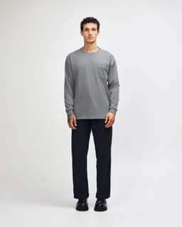 A model wears a grey long-sleeve t-shirt paired with khaki cargo pants and sneakers.