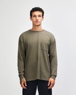 A long-sleeved, olive green heavyweight T-shirt featuring a pocket and a logo.