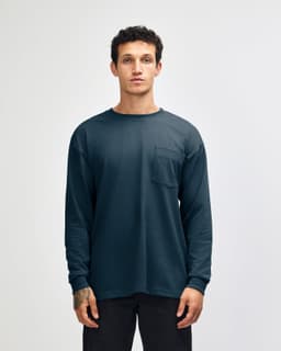 A dark blue long-sleeve t-shirt with a pocket, featuring a simple design and a logo.