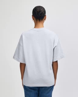A grey oversized unisex boxy top from American Apparel, featuring a simple design and short sleeves.