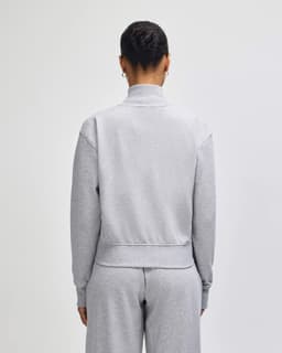 A grey French Terry women's full-zip jacket, viewed from the back, featuring a simple design and no visible branding.