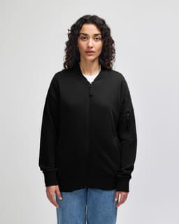 A black unisex bomber jacket made of French terry fabric, featuring a zip front and ribbed cuffs.