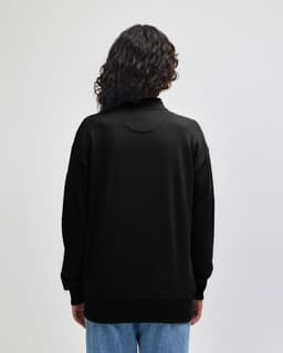 A black unisex bomber jacket with a relaxed fit, featuring a round neck and long sleeves.