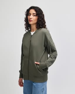 A unisex bomber jacket in olive green featuring a front zipper, side pockets, and a logo on the sleeve.