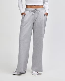 Wide leg pants in light grey, featuring an elastic waist and side pockets. The model wears a fitted top.