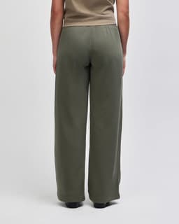 Wide leg pants in olive green, featuring a comfortable elastic waistband. The design is simple and relaxed.