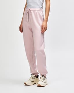 Unisex sweatpants in soft pink, featuring a snug fit and side pockets. Includes a visible logo detail.