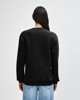 A unisex crewneck sweatshirt in black, featuring long sleeves and a relaxed fit, with a logo on the back.