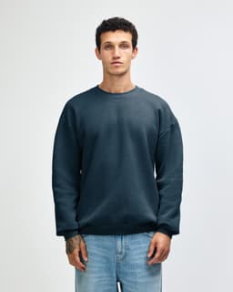 A unisex crewneck sweatshirt in a deep blue colour, featuring a simple design and a logo.