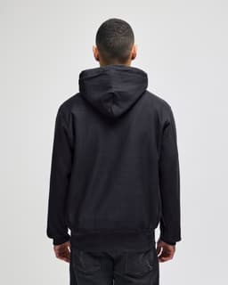 A black hooded sweatshirt with a kangaroo pocket, featuring a logo on the back, displayed from the rear.
