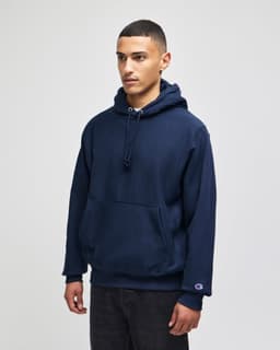 A navy hooded sweatshirt with a front pocket and a logo on the sleeve.