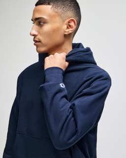 A navy blue Champion Reverse Weave® adult pullover hooded sweatshirt with a logo on the sleeve.
