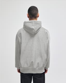 A grey hooded sweatshirt featuring a kangaroo pocket and a logo on the back.