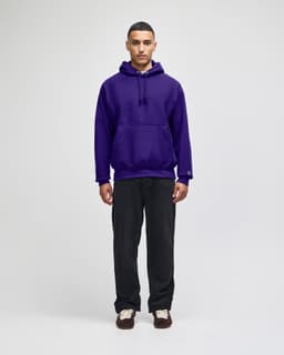 A purple pullover hooded sweatshirt with a front pocket and a logo, paired with dark pants.
