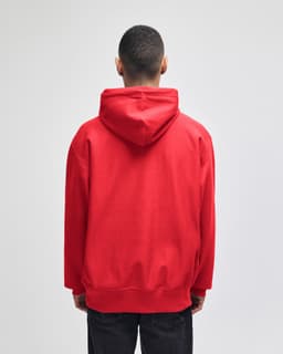 A red pullover hooded sweatshirt featuring a logo, viewed from the back.