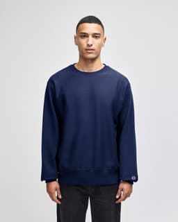 A navy blue adult crew sweatshirt featuring a logo, with long sleeves and a relaxed fit.