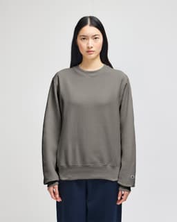 A grey Champion Reverse Weave® adult crew sweatshirt with long sleeves and a relaxed fit, featuring a logo.