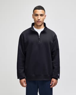 A black quarter-zip pullover with a relaxed fit, featuring a collar and a logo on the sleeve.