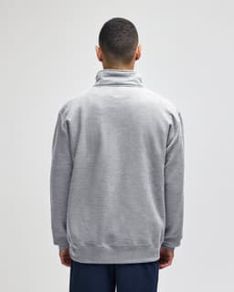 A grey quarter-zip pullover jacket displayed from the back, featuring a collar and a logo.