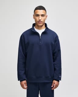 A navy blue quarter-zip pullover with a relaxed fit and branding on the sleeve.