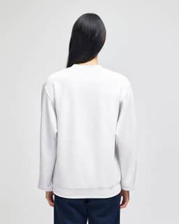A white crewneck sweatshirt with long sleeves, featuring a logo on the back.