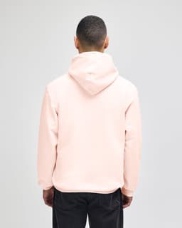 A beige pullover hooded sweatshirt with a loose fit and a hood, viewed from the back.